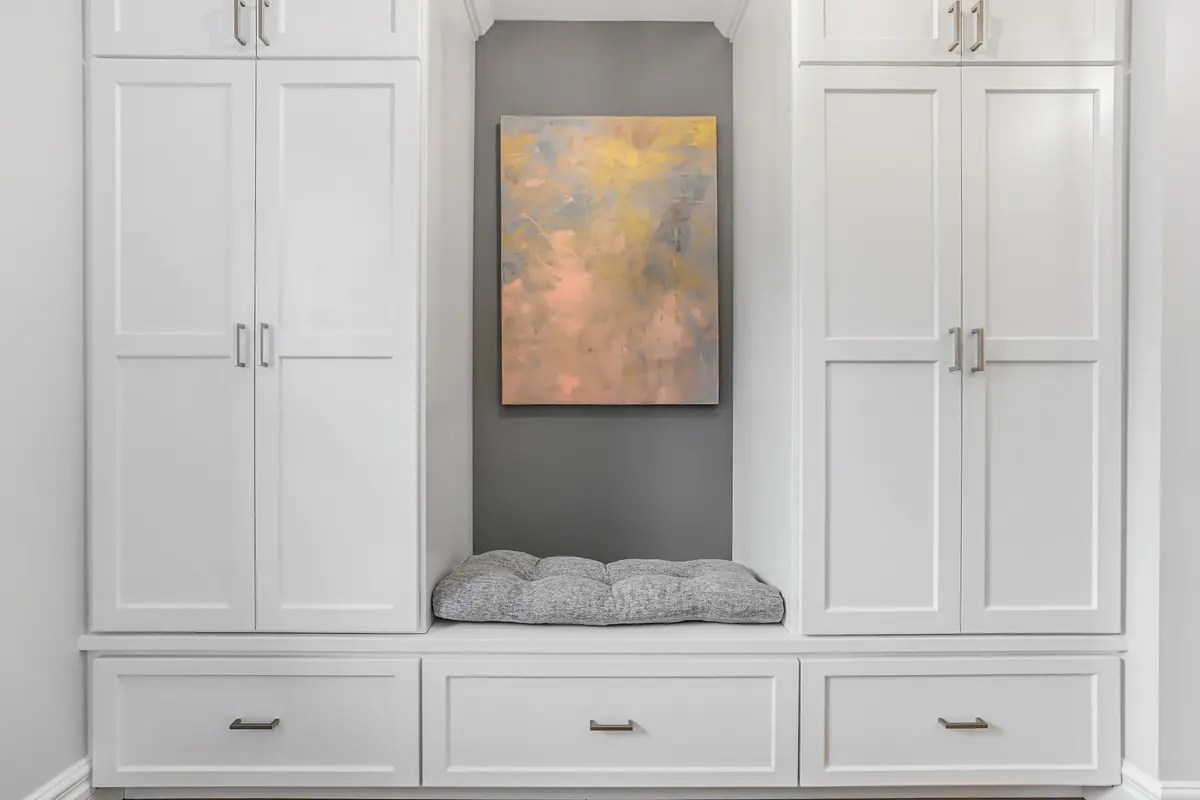 Painted mudroom built-ins with crisp trim and coordinated wood details.