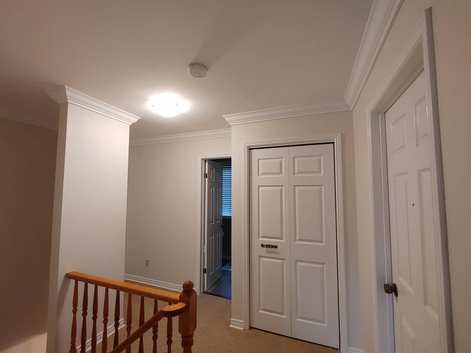 Light hallway walls with white painted trim.